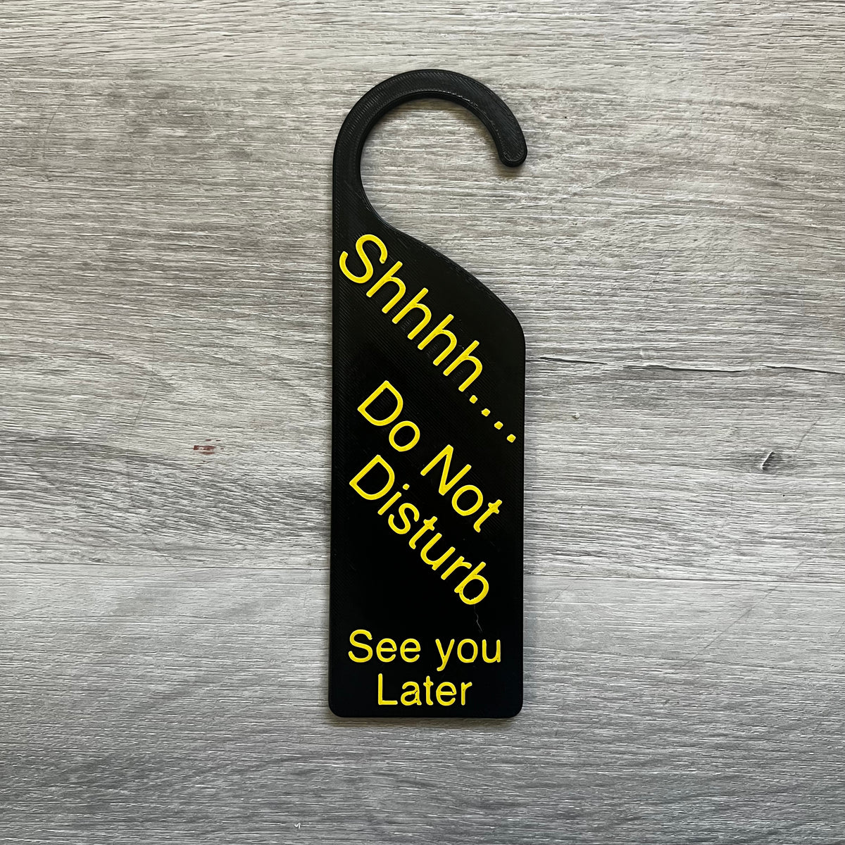 3D printed Shhhh Do Not Disturb door knob sign hanging on a door handle, made in Brisbane Australia