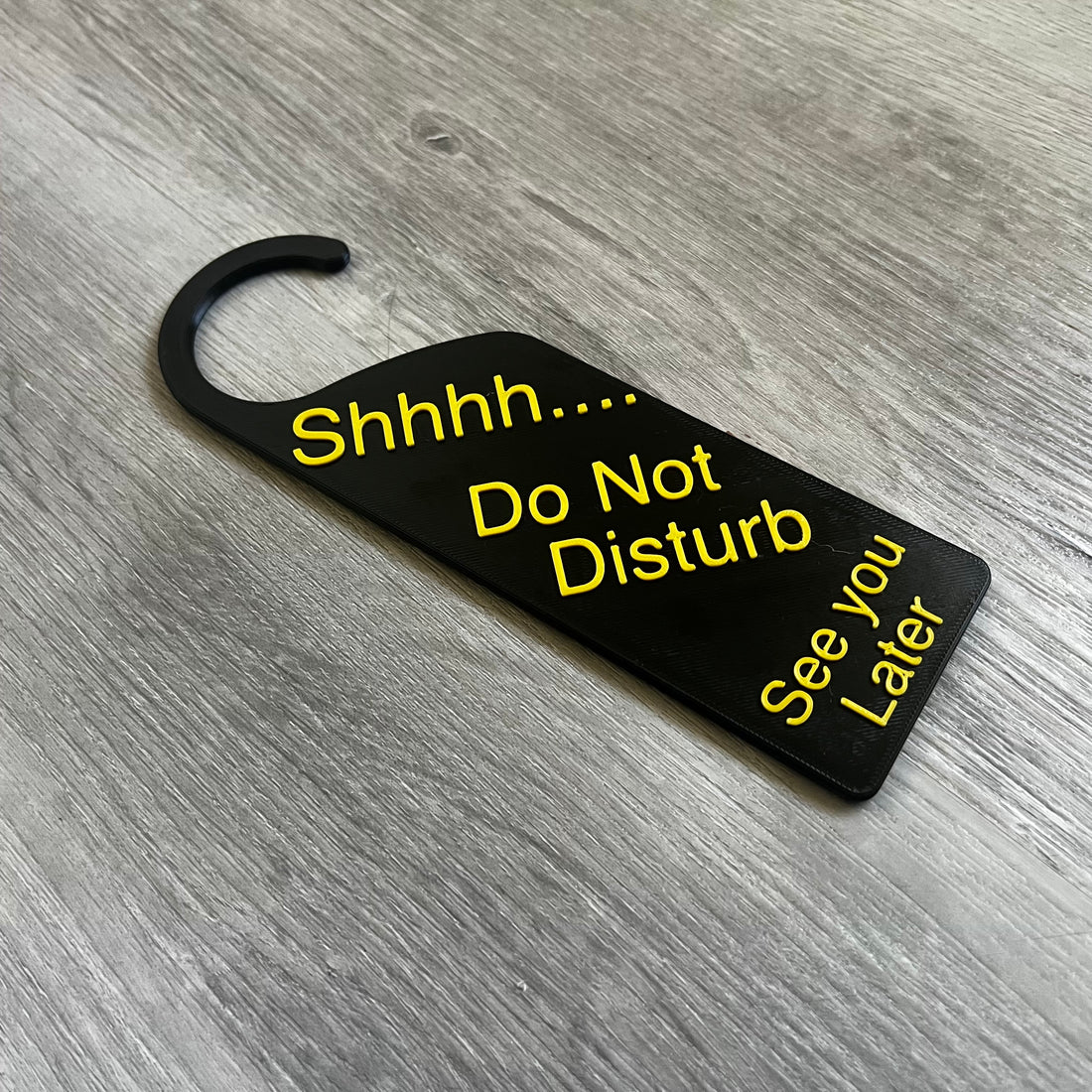 3D printed Shhhh Do Not Disturb door knob sign hanging on a door handle, made in Brisbane Australia