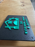 3D printed sign with kitchen-themed design on a wooden surface