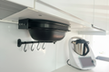 waroma stored under the cupboard with holders