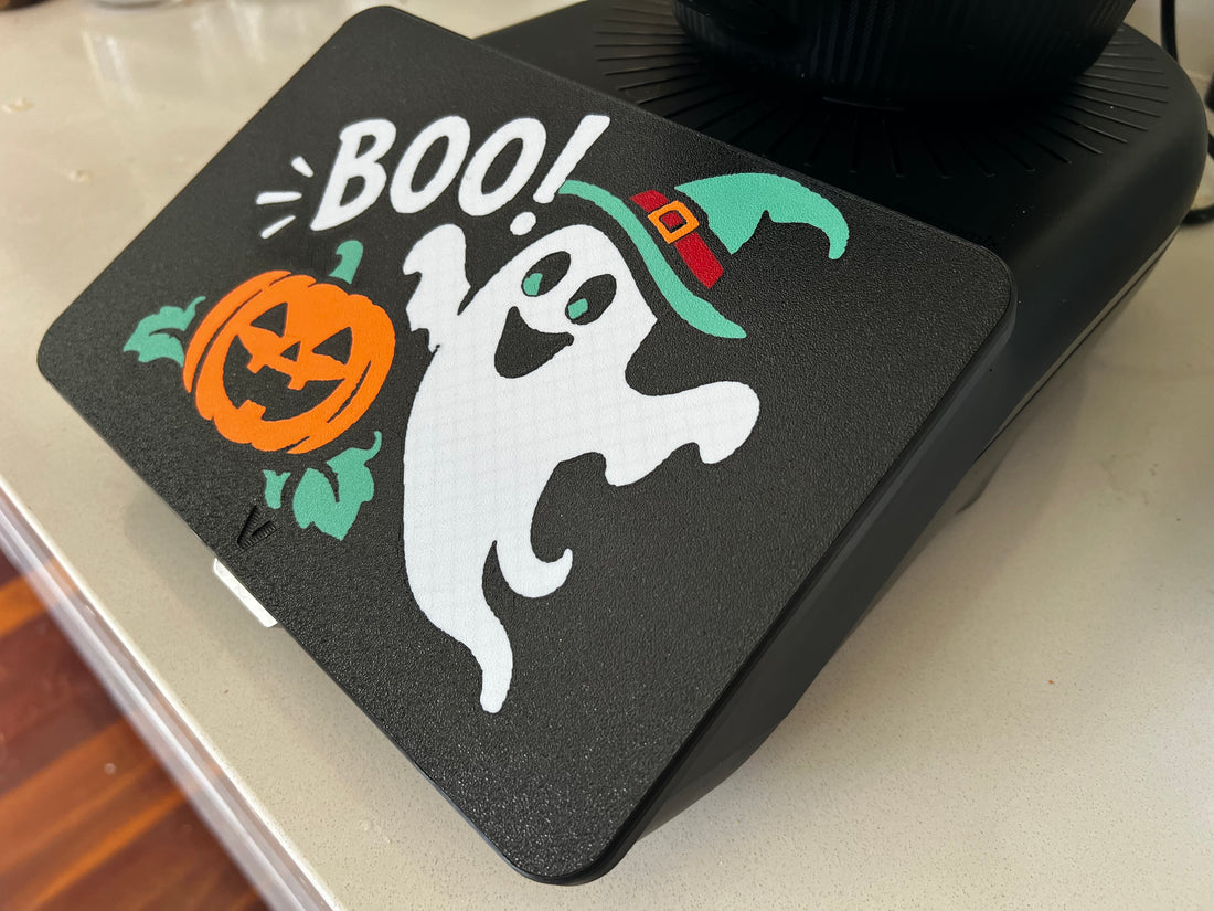 Boo! ghost Halloween screen cover on a Thermomix TM7 — white ghost in a teal witch hat beside a jack-o'-lantern, 3D printed on black